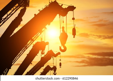 silhouette crane truck in flare light for logistic background 
