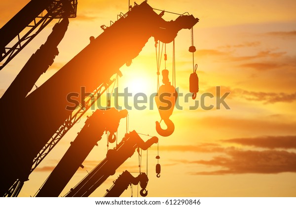 silhouette crane truck in flare light for logistic\
background 