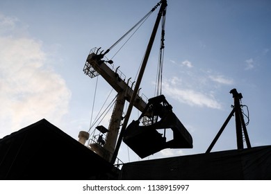 Silhouette Of Cranes When Unloading The Cargo At The Sea Port In Belawan, Indonesia