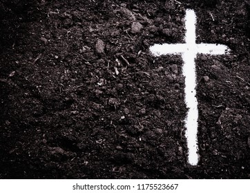The silhouette of cross against of soil background. The cross as symbol for Jesus Christ. Christianity, religion, faith concept.