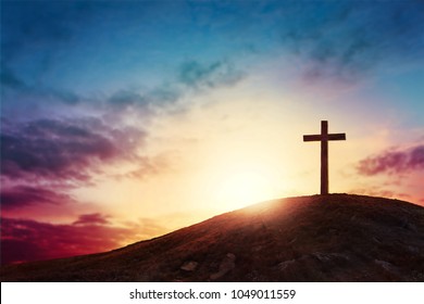 Silhouette cross on Calvary mountain sunset background. Easter concept - Shutterstock ID 1049011559
