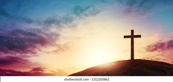 Silhouette Cross On Calvary Mountain Sunset Background. Easter Concept