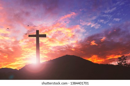 Silhouette the cross on sunset background