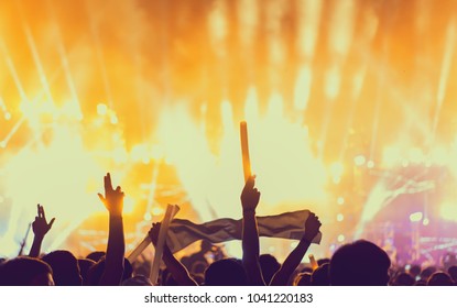 Silhouette Crowd Of Concert Stage Lights And People Fan Audience Raising Hands Or Glow Stick Holding In The Music Festival Rear View 