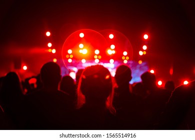 Silhouette Of The Crowd At A Rock Concert. The Audience Cheers And Claps The Musician On The Stage.