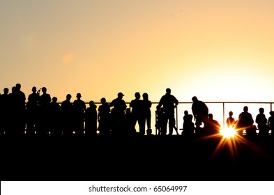 Silhouette Of Crowd At Sporting Event At Sunset