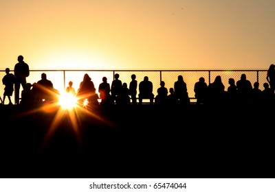 Silhouette Of Crowd At Sporting Event At Sunset