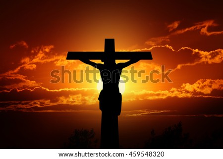Silhouette crucifixion of Jesus and the sunset.