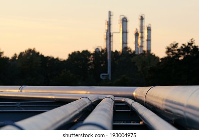 Silhouette  Of Crude Oil Refinery Station During Sunset With Long Pipes