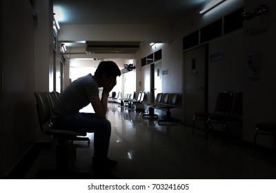 Silhouette Of A Crying Man Waiting For His Wife Or Family In The Hospital About Emergency Accident Or Deadly Disease 