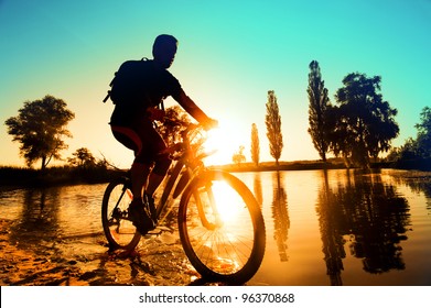 silhouette of a cyclist near the river Irpen, Kiev, Ukraine - Powered by Shutterstock