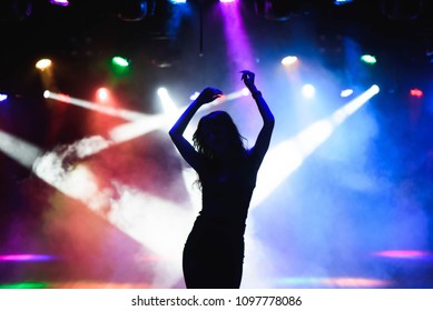 Silhouette Of Dancing Girl Against Disco Lights