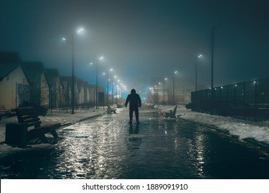 Silhouette of dark man in hood in night illuminated city alley in foggy weather, misty horror and scary atmosphere concept - Powered by Shutterstock