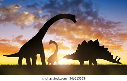Silhouette of dinosaurs in the sunset.