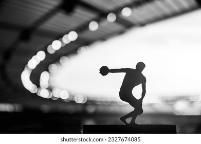 Silhouette of Discus Thrower, Focused and Determined in Mesmerizing Evening Ambiance. Track and Field Photo for Summer Games in Paris. - Powered by Shutterstock