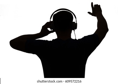 Silhouette Of A DJ. He Is Raising His Arms.