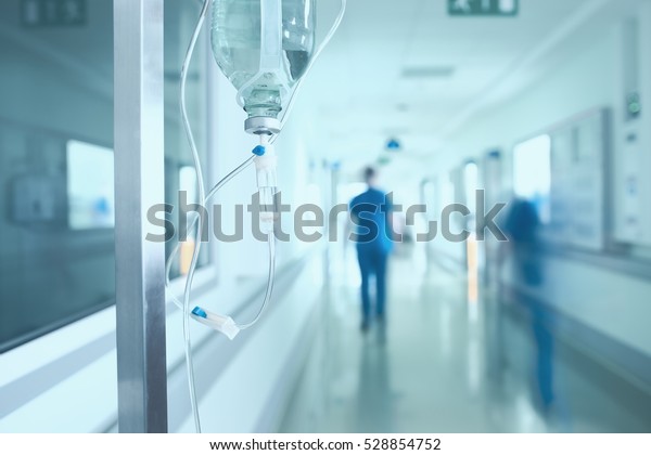 Silhouette of a doctor walking in a hurry in\
the hospital\
corridor.