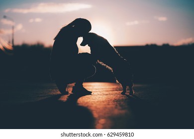 Silhouette Of A Dog And A Man