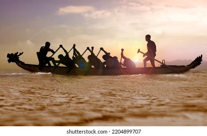 Silhouette of a Dragon boat with people paddling at sunset  - Shutterstock ID 2204899707