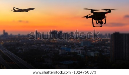 Silhouette of drone flying near an airport with airplane, no drone zone concept
