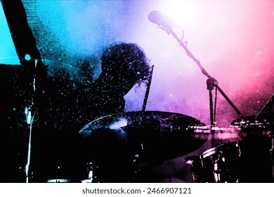 Silhouette of a drummer playing under vibrant pink and blue stage lights, capturing the energy and motion of a live music performance.
 - Powered by Shutterstock