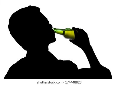 Silhouette of drunk man drinking a bottle of beer
