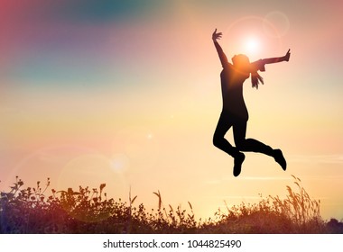 Silhouette Dual Women Jumping Graduation with Congratulation.happy woman with Good New concept in sunset background.With Copy Space. - Powered by Shutterstock