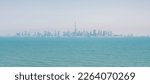 Silhouette of Dubai with sea in haze