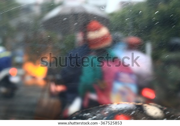 Silhouette edge The rain is\
falling. Bokeh on the road in the morning. In Thailand.Abstract\
blurred background : Traffic jam in the morning rush hour.\
in-Thailand.