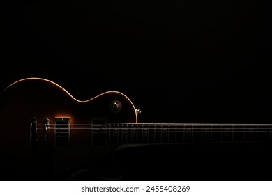 Silhouette of an electric guitar placed on a black background - Powered by Shutterstock