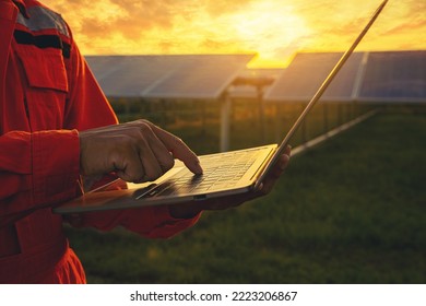 Silhouette of Electrical, instrument technician working with laptop, maintenance electric system at sunset solar panel field. Selected focus