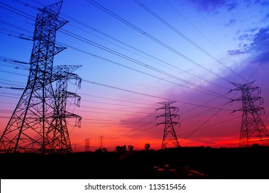 Silhouette Electricity Pylons During Sunset