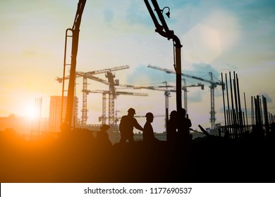 Silhouette of engineer and construction team working at site over blurred background for industry background with Light fair.