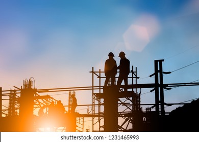 Silhouette Of Engineer And Construction Team Working At Site Over Blurred Background For Industry Background With Light Fair.