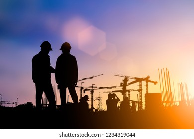 Silhouette Of Engineer And Construction Team Working At Site Over Blurred Background For Industry Background With Light Fair.