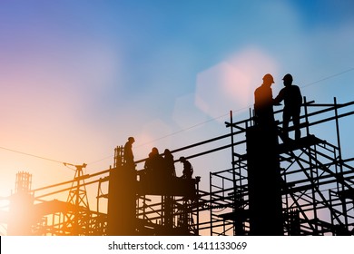 Silhouette of engineer and construction team working at site over blurred background for industry background with Light fair.