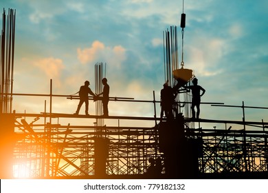 Silhouette of engineer and construction team working at site over blurred background sunset pastel for industry background with Light fair. - Shutterstock ID 779182132
