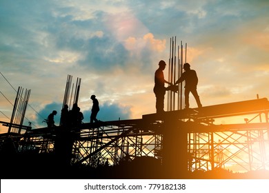Silhouette of engineer and construction team working at site over blurred background sunset pastel for industry background with Light fair. - Shutterstock ID 779182138