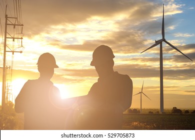 Silhouette Of Engineer And Foreman At Wind Turbine Electricity Industrial In Sunset