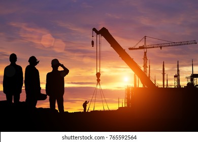 Silhouette engineer standing orders for construction. Light at sunset