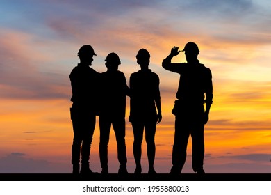 Silhouette of engineer and worker team with clipping path standing with hands on shoulders sunset background, Success and Teamwork Concepts