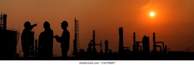 Silhouette engineer working in Petrochemical industry area. Petrochemical industry on sunset and Twilight sky, Energy power station area. Petrochemical industry with worker or engineer.