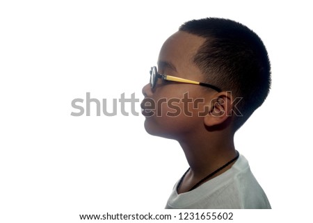 silhouette of the face of a boy looking upwards isolated on a white background.