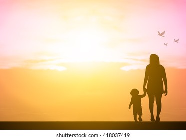 Silhouette Of Family On The Outdoor At Sunset On The Beach Background. Hope And Help From Blessing God Concept. Life Goes On Concept. It Will Be Better Tomorrow Concept.mother Day.Family Day. Care You