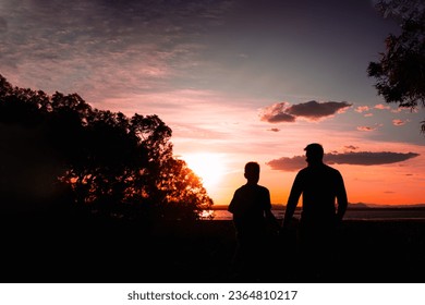 silhouette of father and son against nature background with raised hands,concept of family success - Shutterstock ID 2364810217