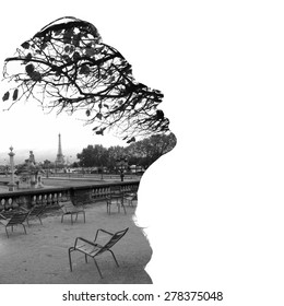 Silhouette of a female head (profile), framing fragment of Paris panorama with the Eiffel Tower in the background, double exposure. Black and white photo, bright background