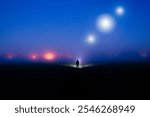 A silhouette of a figure, standing in the countryside on a foggy night, with glowing lights of UFO