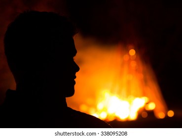 A silhouette with a fire background 