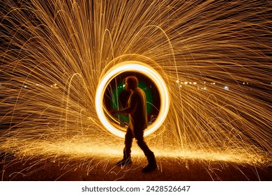 Silhouette with Fire Ring Light Painting, Long Exposure Sparks - Powered by Shutterstock