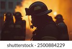 silhouette of firefighters, after extinguishing the fire, carrying out fire extinguishing duties